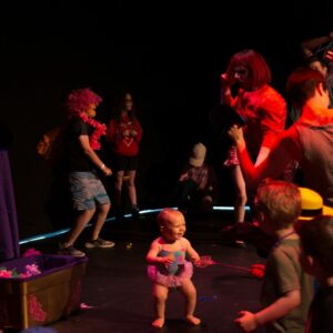 Image of children dancing and smiling with the performers from the Parents are still a Drag performance