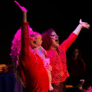 Photo of drag performers waving and smiling, from the Parents are still a drag performance taking place June 3rd-5th