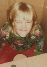 Image of KELLY CREELMAN Audience Services, when she was a kid, winking at the camera.