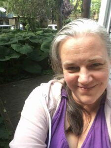 Selfie of our new Audience Services Manager, Kelley Creelman, smiling in a purple shirt