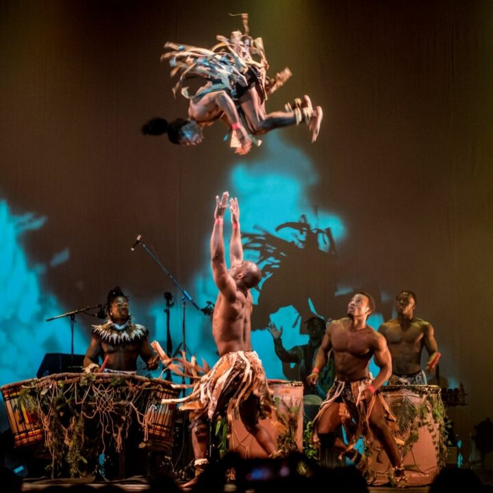 Image of circus performers from the Won’Ma Africa group throwing one member in the air. Join us on May 31st-June 5th for this thrilling performance.