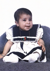 A toddler in a black and white dress