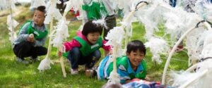 Image if children crawling through a tunnel of white banners