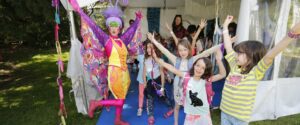 Image of a group of students smiling beside a woman in a butterfly costume