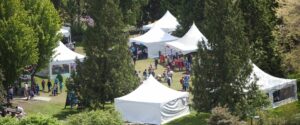 Image of white tents in the activity village in forest from above