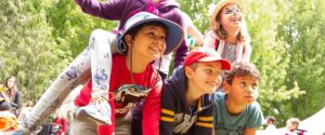 Image of a group of children smiling and laughing outside