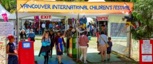 Image of a group of students walking through a yellow Vancouver International Children’s Festival gates