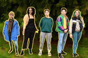 Members of the ‘One of a Kind’ performance group smiling at the camera next to each other, in front of the tree.