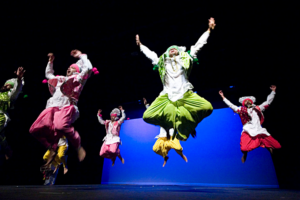 Performers from the Bhangra dance performance jumping in the air