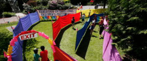 Image of people walking through a brightly coloured outdoor maze