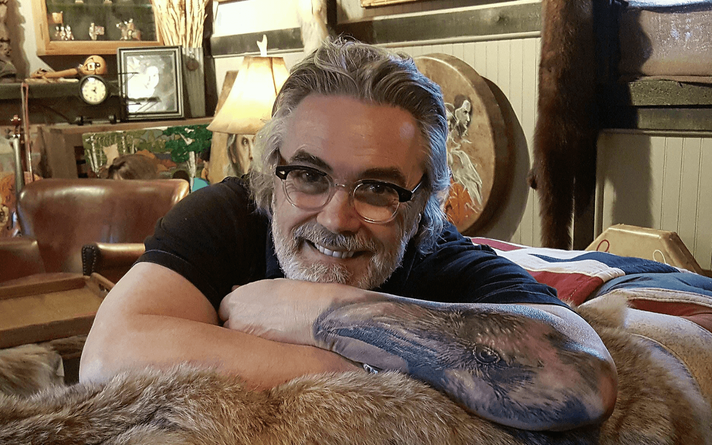 David Bouchard smiling, with a couch and lamp in the background