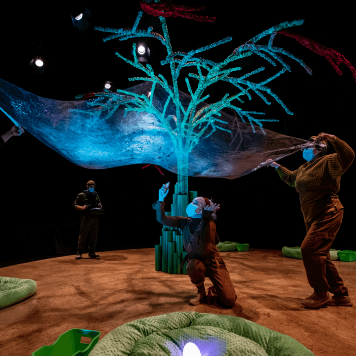 A large bubble stretches across the stage lit up with blue light.