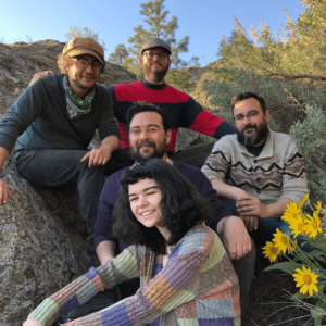 An image of the musical group The Oot n' Oots, smiling with flowers.