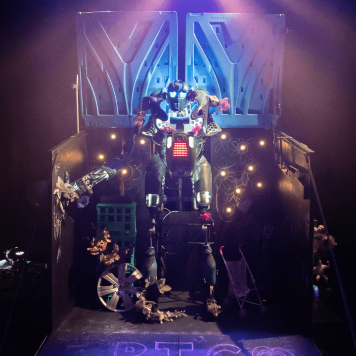 A stage with a robot in front of it.