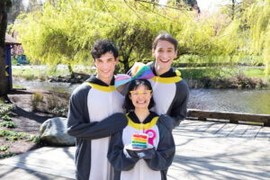 Three people dressed up as penguins at a birthday party