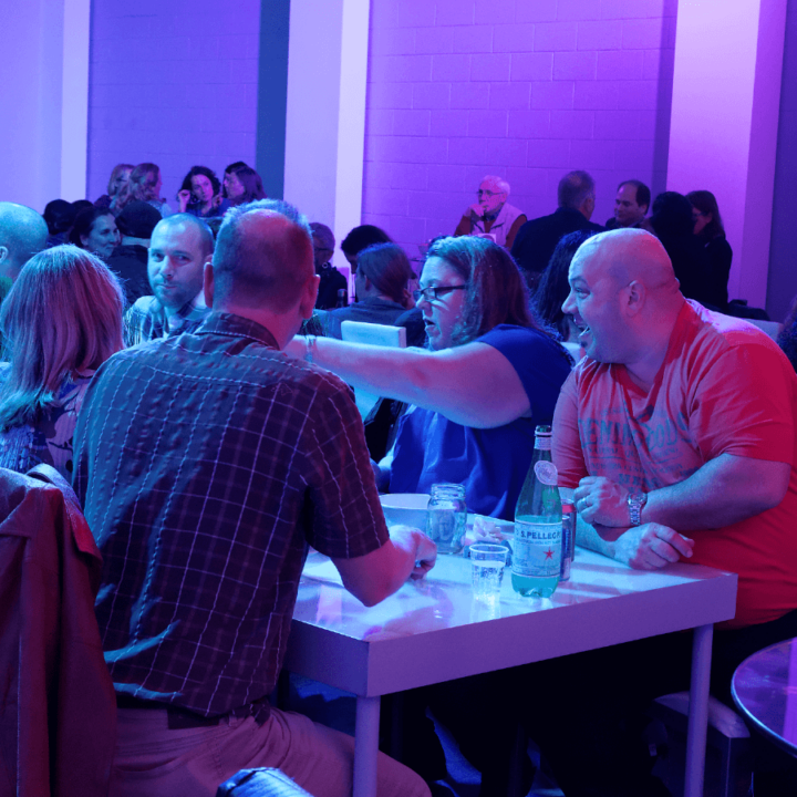 People at a table discussing.