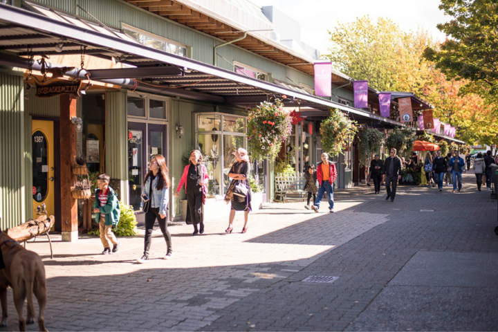 A photograph of people walking outside along Railspur Alley.